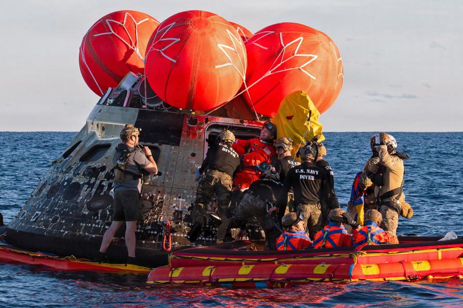 NASA Astronaut Reid Wiseman, Artemis II mission commander, exits the Orion crew module to join the three other crew in a raft