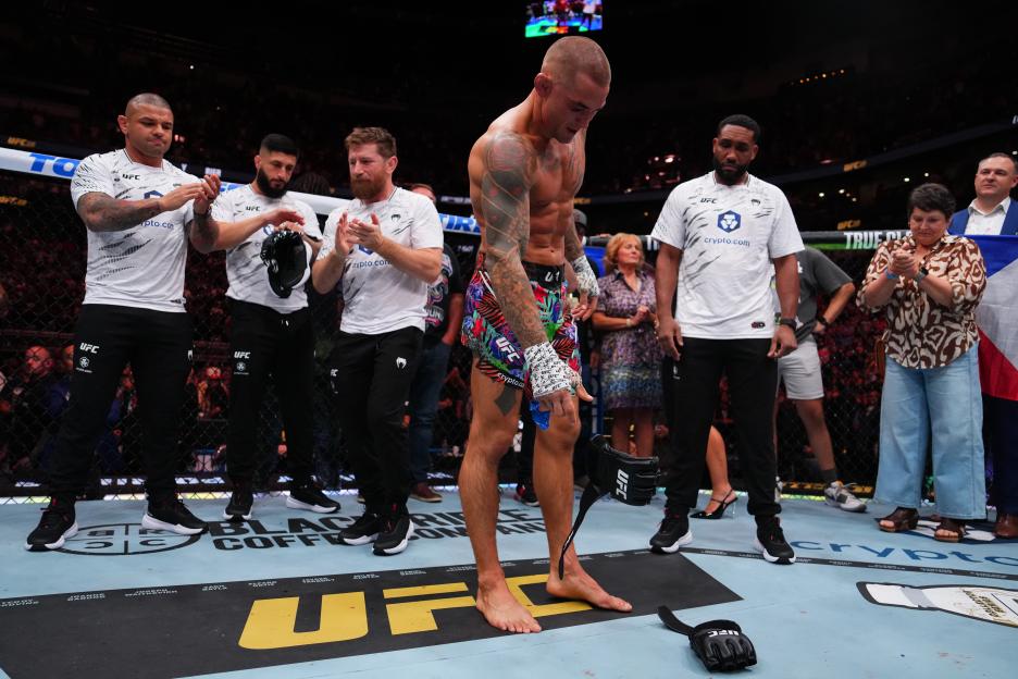 Dustin Poirier placing his gloves on the mat after the BMF championship bout.