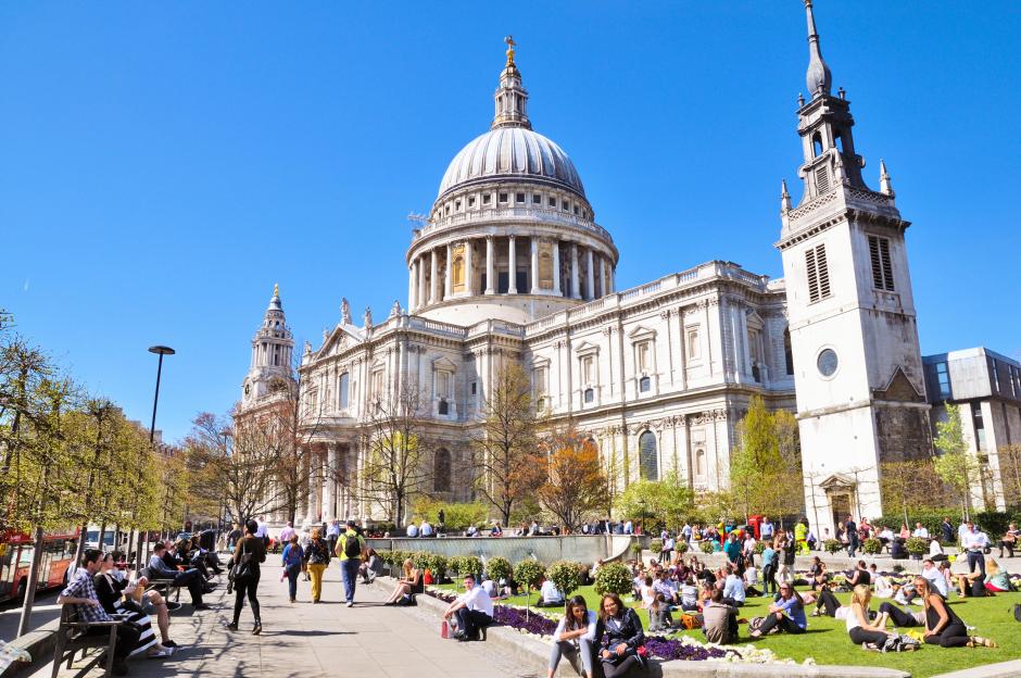 St Paul's Cathedral and Festival Gardens in London with people relaxing on the grass.