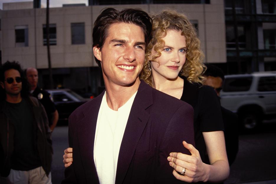 Tom Cruise and Nicole Kidman smiling, with Kidman's arm around Cruise's back.