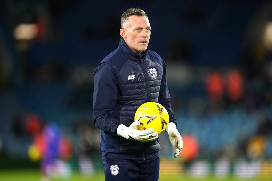 Cardiff City goalkeeping coach Graham Stack holding a yellow soccer ball.