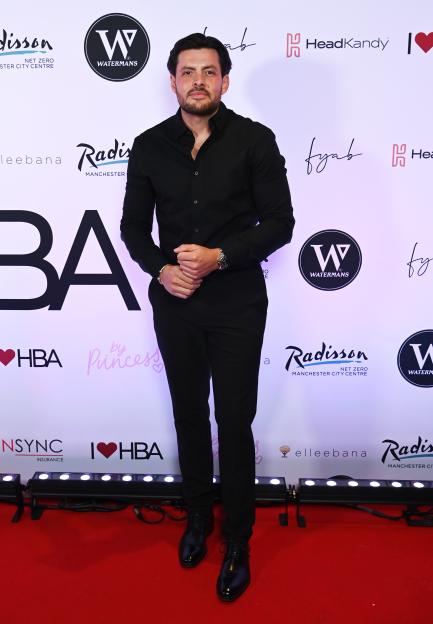 Jordan Brook poses in a black outfit at The Hair and Beauty Awards at The AO Arena in Manchester.