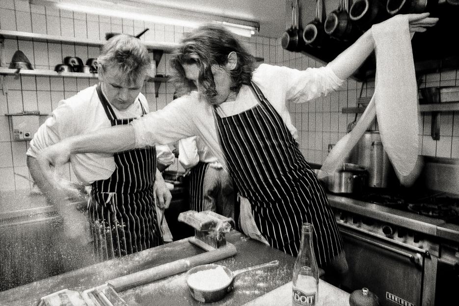 Marco Pierre White and Gordon Ramsay working in a restaurant kitchen.