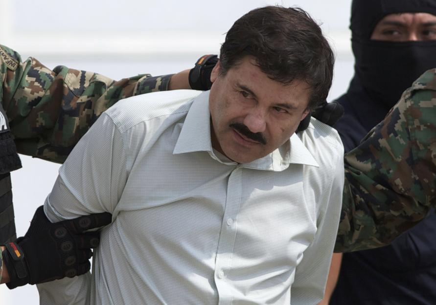 Joaquin "El Chapo" Guzman being escorted by military personnel after his capture.