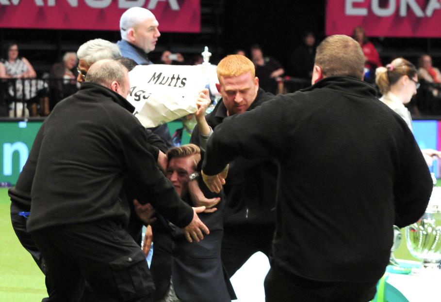 Crufts held at the Birmingham NEC - Day 4 A protester from animals rights organisation PETA holds up a sign that reads Mutts Against Crufts during the Best in Show Featuring: Protester Where: Birmingham, United Kingdom When: 08 Mar 2015 Credit: Antho
