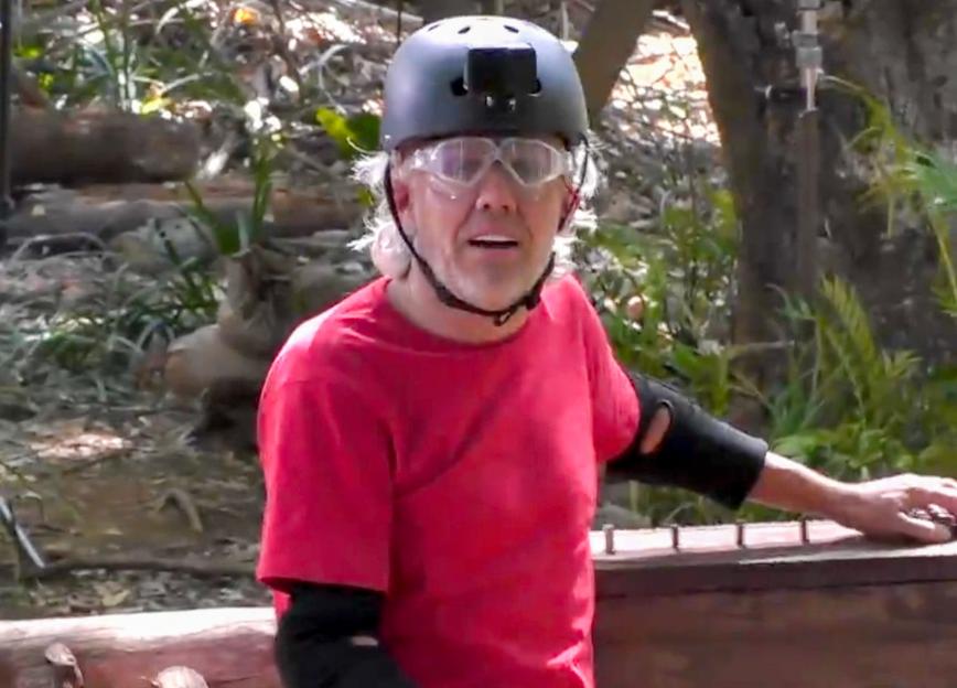 Jimmy Bullard wearing a helmet and safety glasses in a jungle setting.