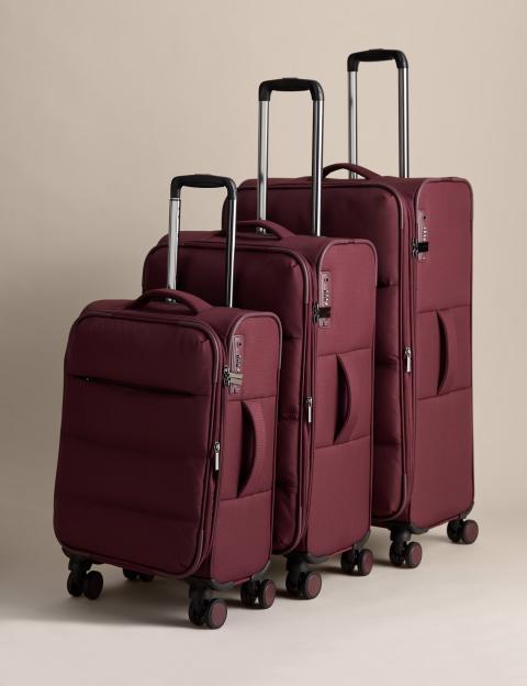 Three burgundy suitcases of varying sizes.