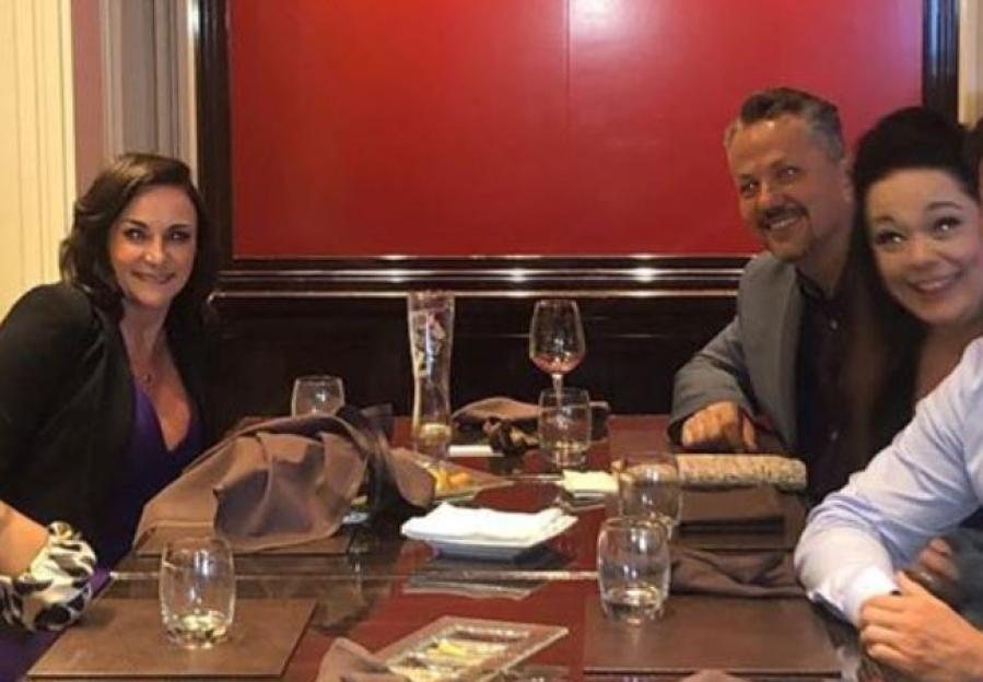 Lisa Riley and her mystery fiancé sitting at a table with another woman.