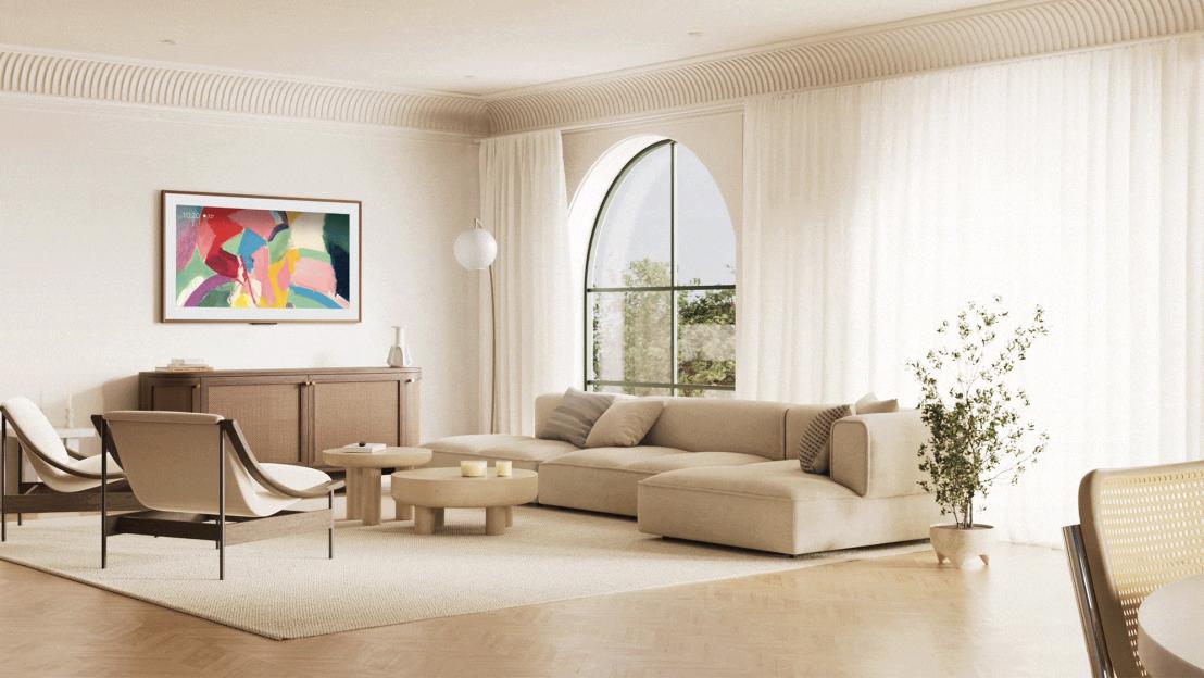 A spacious living room with a large arched window and a mounted TV displaying colorful abstract art.