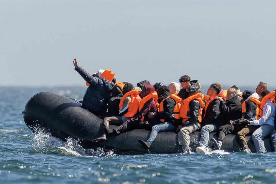 Migrants in an inflatable boat crossing the channel from France to England.