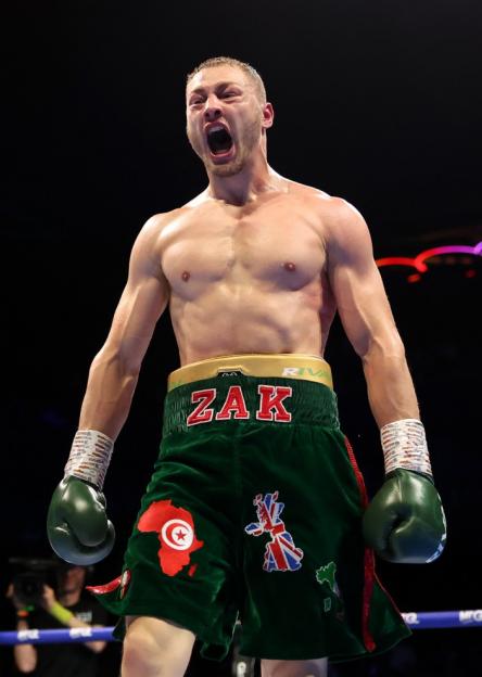 Boxer Zak Chelli cheering in the ring.
