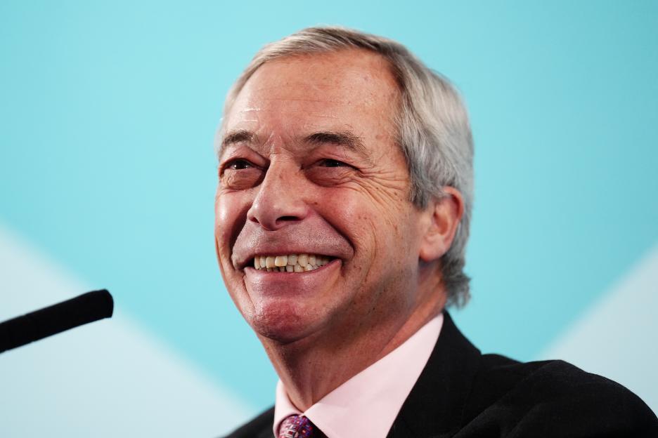 Nigel Farage, leader of Reform UK, smiling during a press conference.