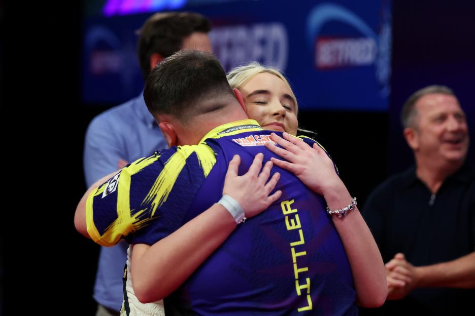 Luke Littler embracing Faith Millar after his victory in the 2025 Betfred World Matchplay final.