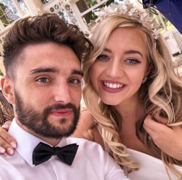 A smiling couple posing together.