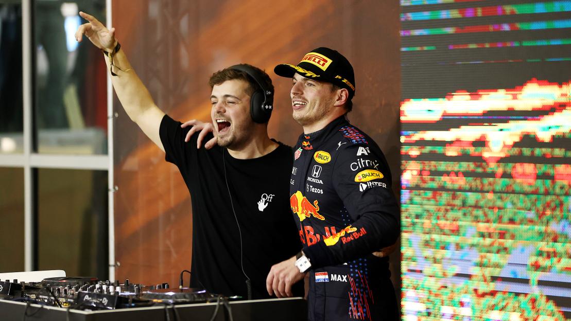 Max Verstappen and DJ Martin Garrix celebrate on the podium.