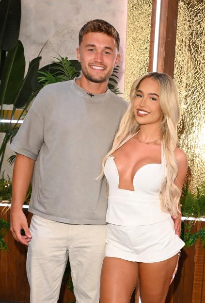 Finley Maddock and Ellie Chadwick smiling at the "Love Island Aftersun" TV Show.