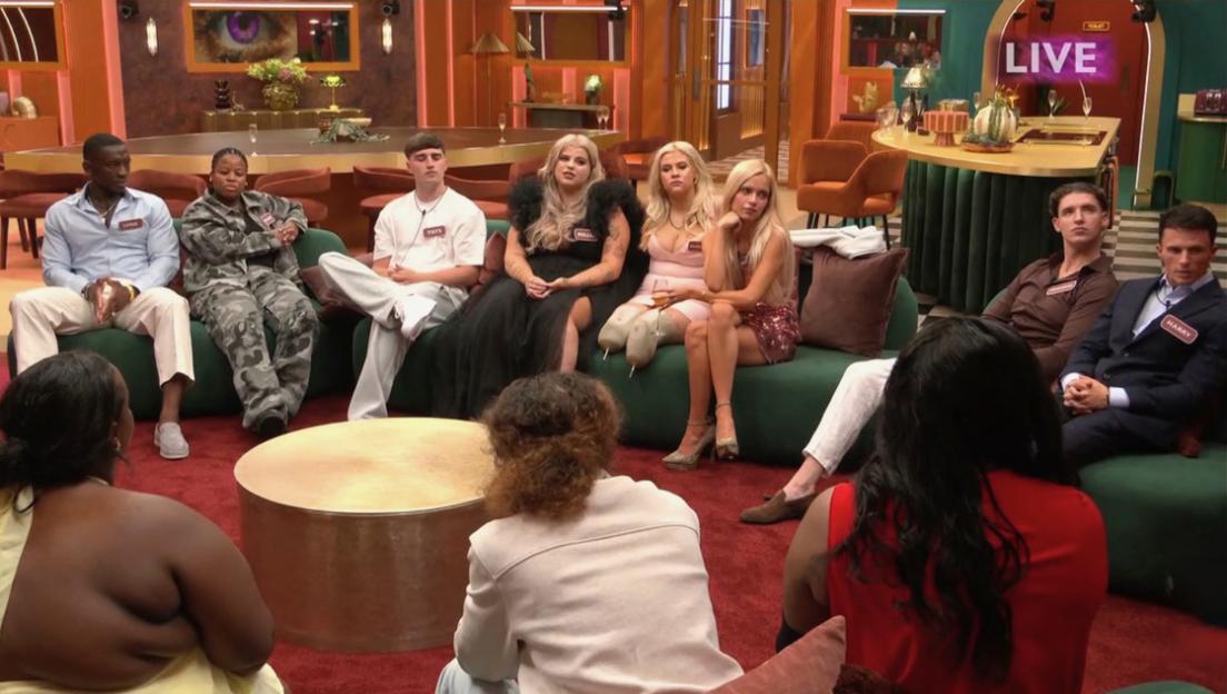 Contestants on Big Brother sit in a living room during the show's launch.