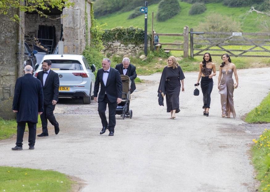 Wedding guests in formal wear arriving at Euridge Manor.