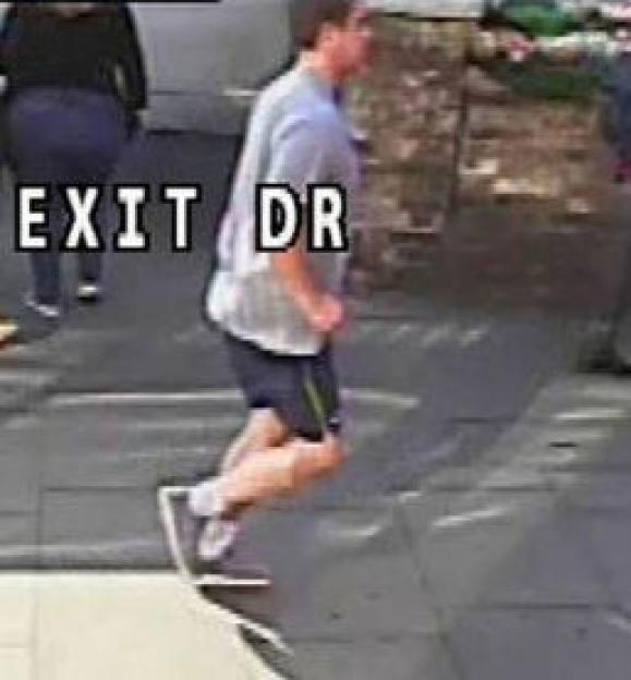 A man jogging whom police wish to speak to after a a woman was pushed into the path of a bus on Putney Bridge is seen in a still image taken from CCTV and handed out by the Metropolitan Police in London