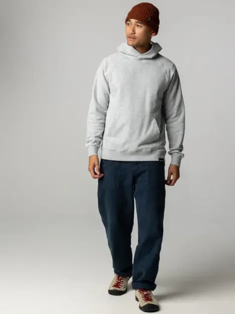A man wearing a grey hoodie and a brown beanie.