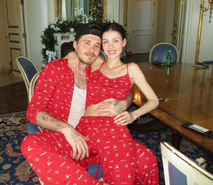 Brooklyn Beckham and Nicola Peltz in matching red Christmas pajamas.