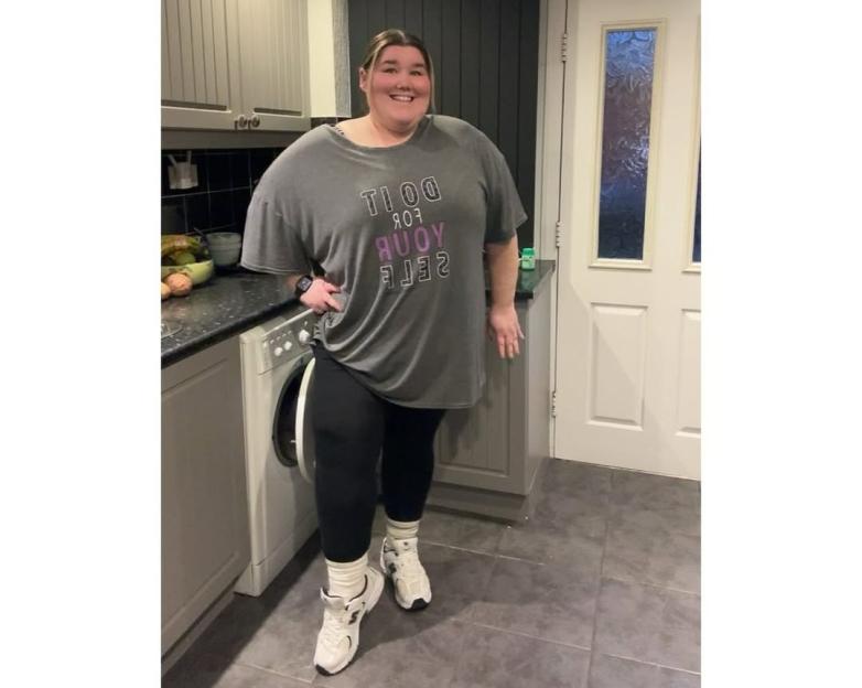Becky Jones posing in a kitchen.