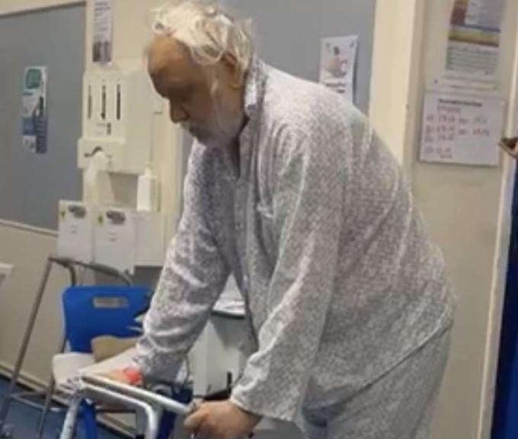 Mr Perkins, hospitalized for alcoholic liver disease, leans on a walker.