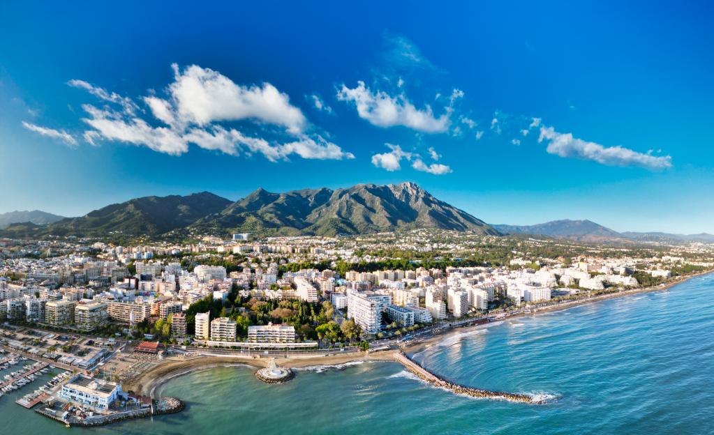 Stunning aerial view of Marbella with coastline, luxury villas, and Mediterranean Sea