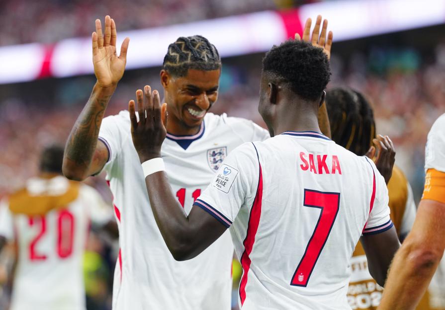 Marcus Rashford and Bukayo Saka celebrating after a goal.