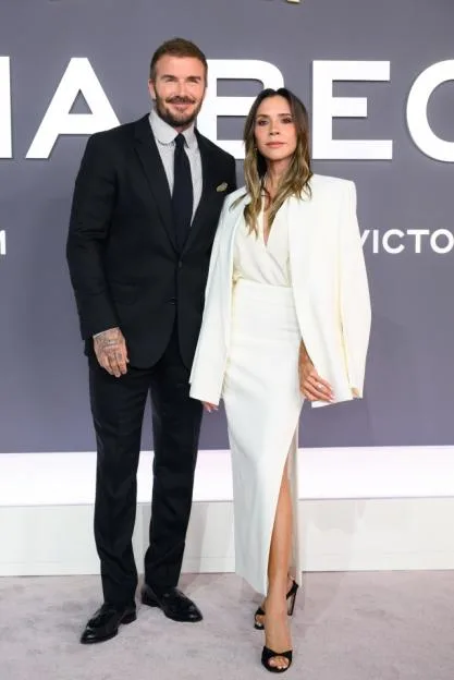 David and Victoria Beckham pose on the red carpet at the "Victoria Beckham" world premiere.