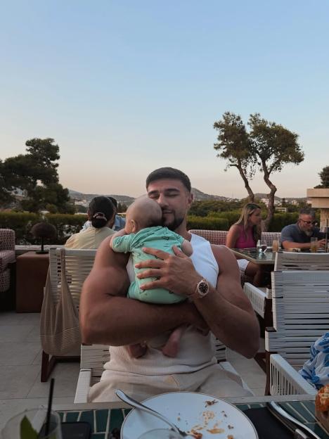 Tommy Fury cradling his baby during a luxury Athens holiday.