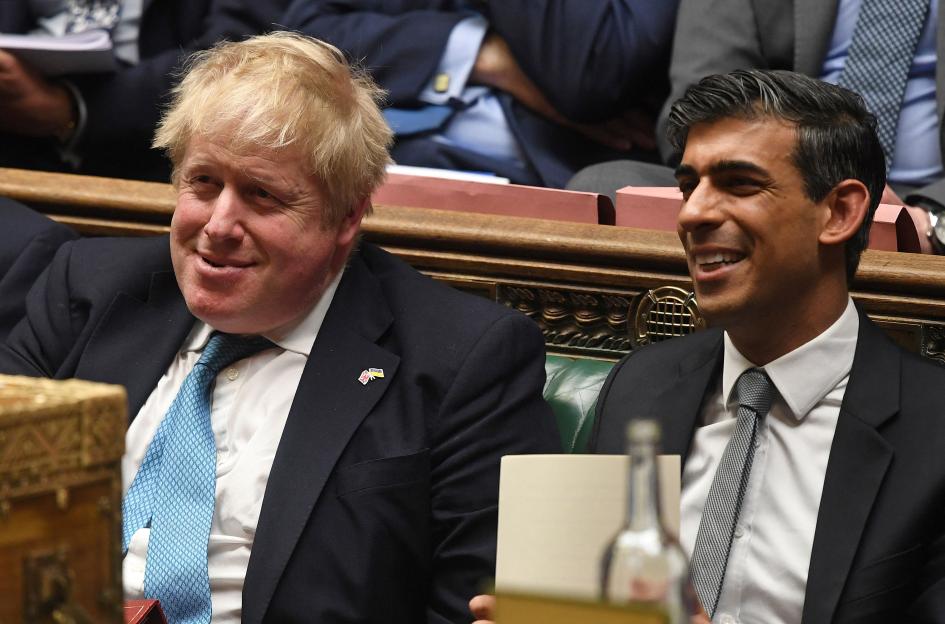 Britain's Prime Minister Boris Johnson (left) and Chancellor of the Exchequer Rishi Sunak (right) smiling at the House of Commons.
