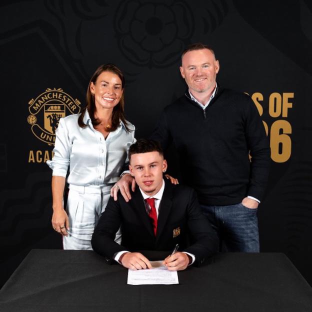 Kai Rooney signing a contract with Manchester United, with his parents Coleen and Wayne Rooney behind him.
