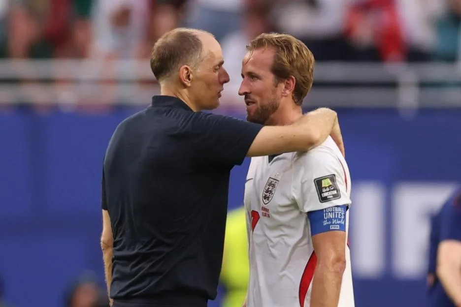 England footballer Harry Kane being embraced by his coach.