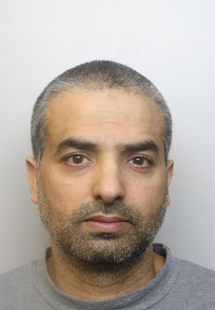 Mugshot of Salman Yousaf, a man with short, dark hair, dark eyes, and a short beard, wearing a grey t-shirt.