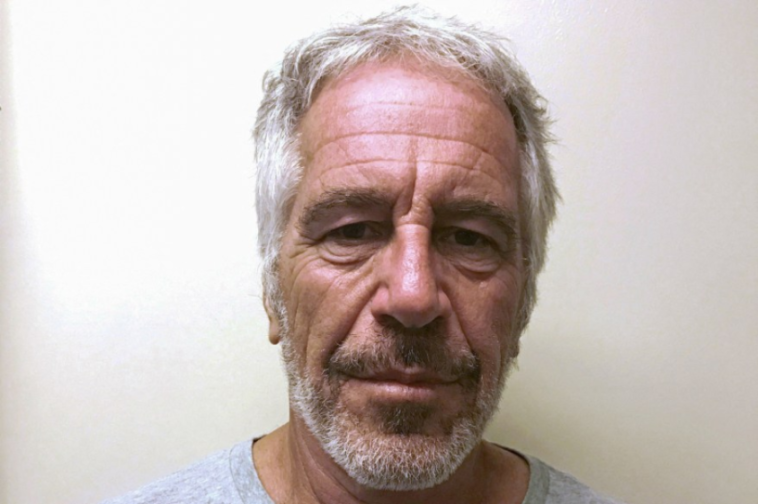 A mugshot of Jeffrey Epstein, a white man with graying hair and beard.