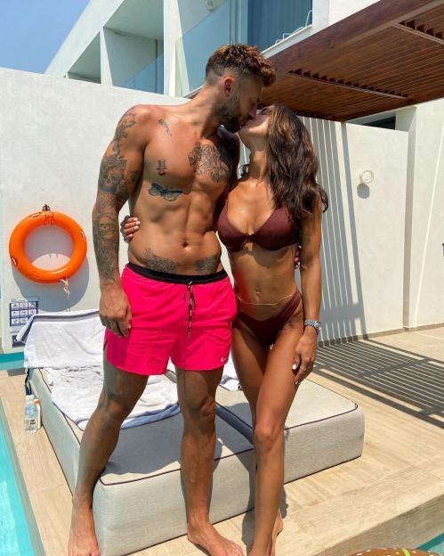 Jake Quickenden and girlfriend Sophie in swimwear, kissing by a pool.
