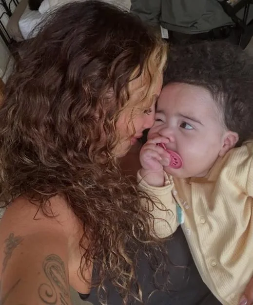 Jesy Nelson cuddling with one of her twin daughters.