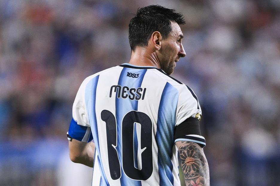 Lionel Messi, wearing an Argentina jersey with "Messi 10" on the back, looking over his right shoulder.