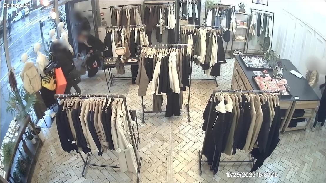 CCTV footage shows two women shoplifting from a clothing store.