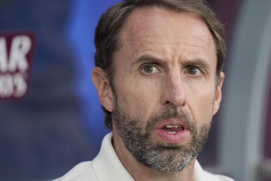 A close-up of Gareth Southgate with a beard and light brown hair, looking slightly to the right with his mouth open.