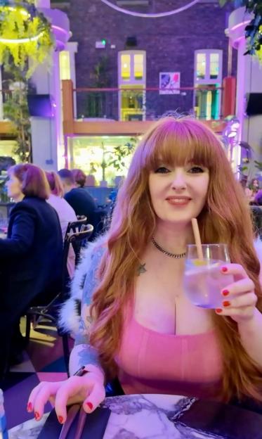 Laura Kerr holding a cocktail glass.