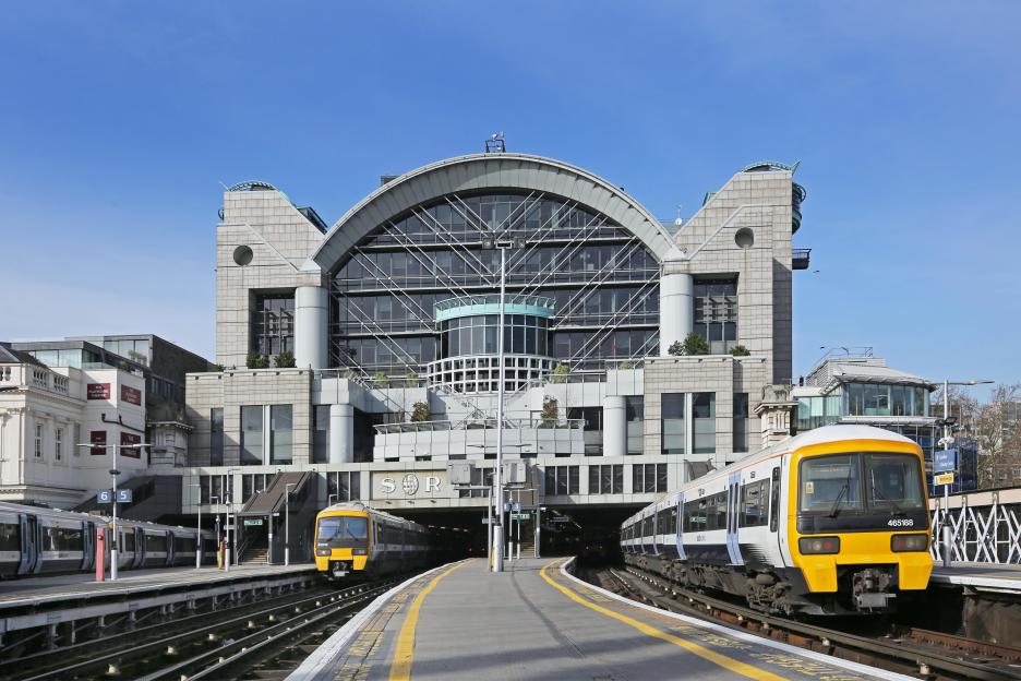 Charing Cross Station, London, with Embankment Place, a post-modern block built in 1990 by architect Terry Farrell, visible above the platforms.