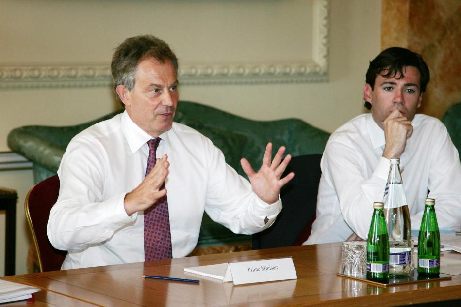 Tony Blair speaks to NHS representatives with Health Minister Andy Burnham listening at a health summit.
