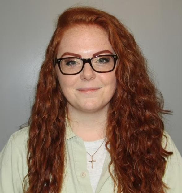 Rachel Shoaf with long red hair and glasses.