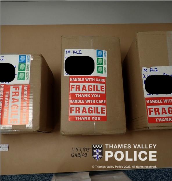 Three brown parcels marked "FRAGILE" and addressed to "M. ALI," with the Thames Valley Police logo.