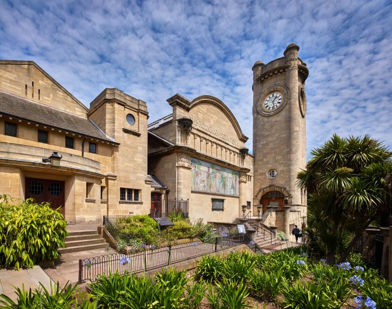 The Horniman Museum and Gardens with its clock tower on a cloudy day.
