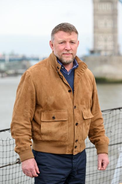 Director Guy Ritchie in a brown jacket at a London photocall.