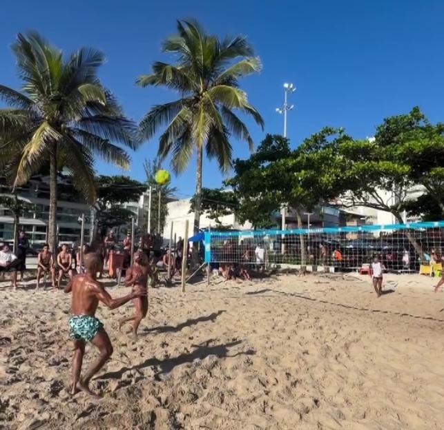 Romario playing beach volleyball on a sunny day.