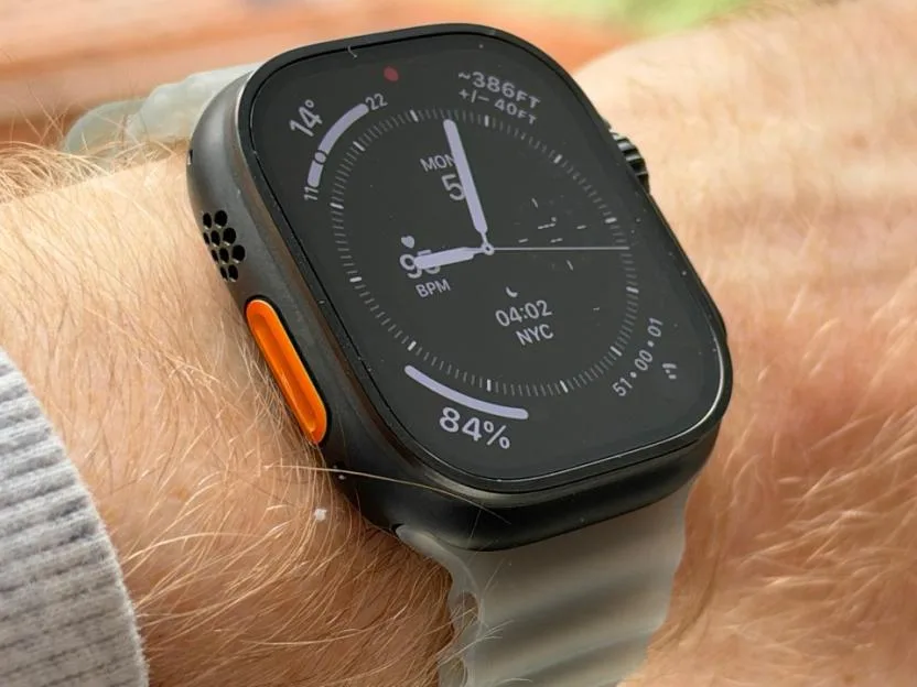 Apple Watch Ultra worn on a wrist, displaying a custom watch face with health and activity metrics.